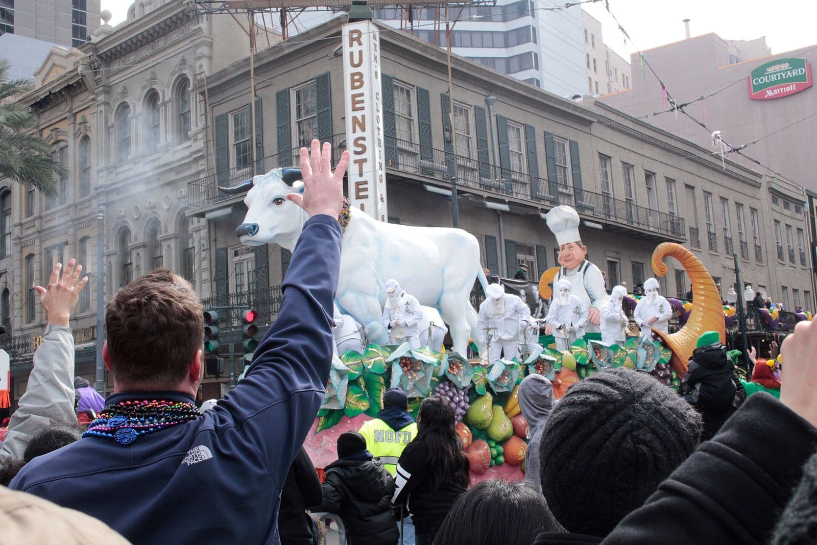 The Rex parade on Mardi Gras Day turning from St. Charles Avenue onto Canal Street, with the white Boeuf Gras float and crowds reaching up
